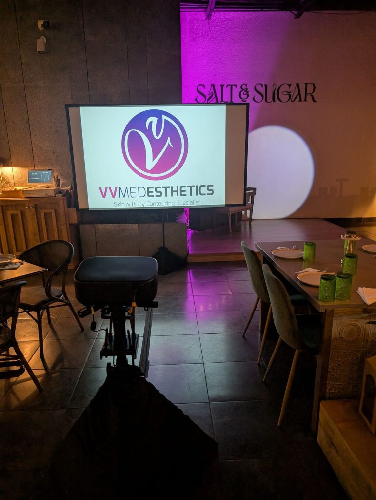 Screen on a stand displaying a company logo at a corporate event