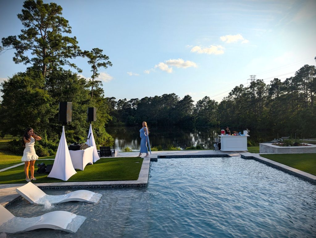 Poolside outdoor ceremony setup at sunset